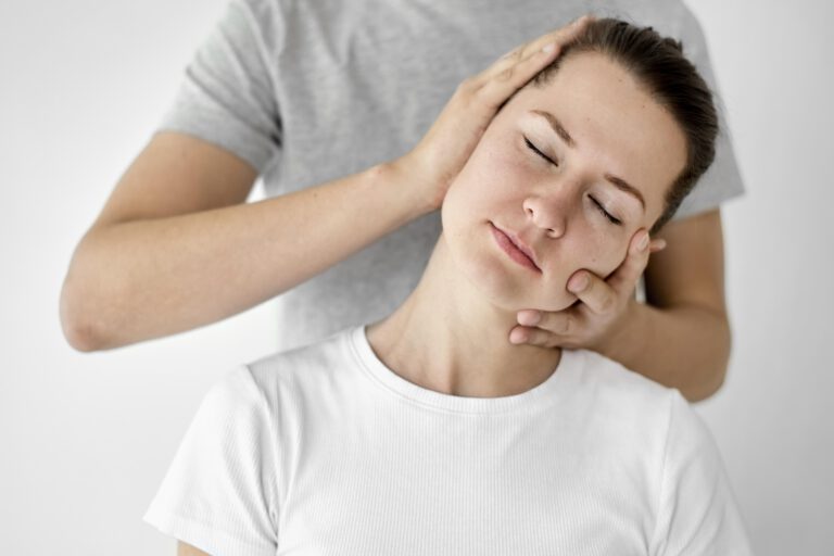 therapist-undergoing-physical-therapy-with-female-patient